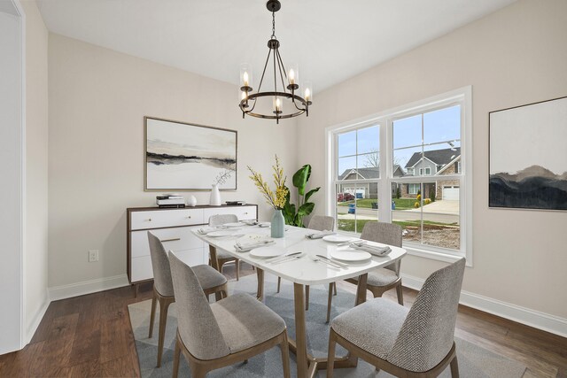 kitchen with pendant lighting, white cabinets, sink, dark hardwood / wood-style floors, and appliances with stainless steel finishes