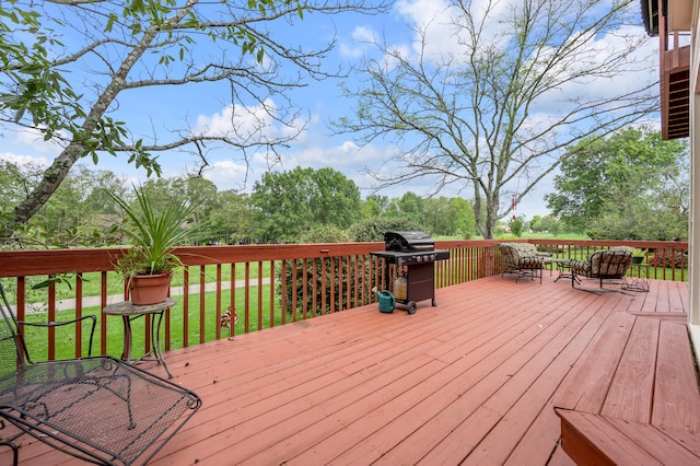 wooden terrace featuring a yard