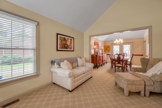 living room with a chandelier and high vaulted ceiling