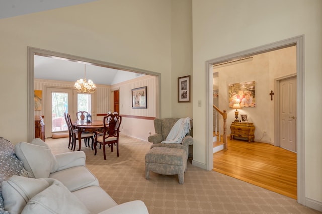 living room featuring light hardwood / wood-style flooring and an inviting chandelier