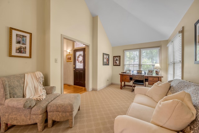 living room featuring light colored carpet and high vaulted ceiling