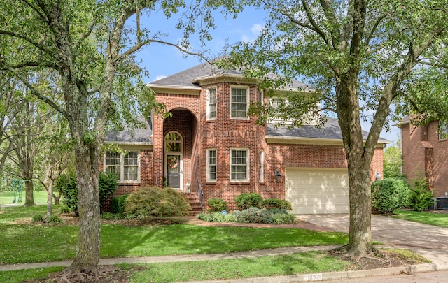 view of front of home with a front yard and a garage