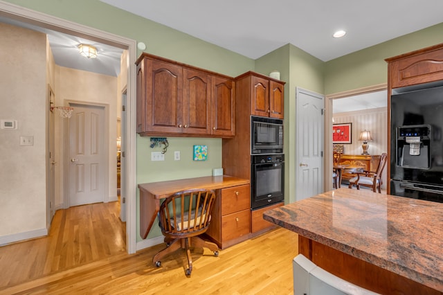 kitchen with black appliances and light wood-type flooring