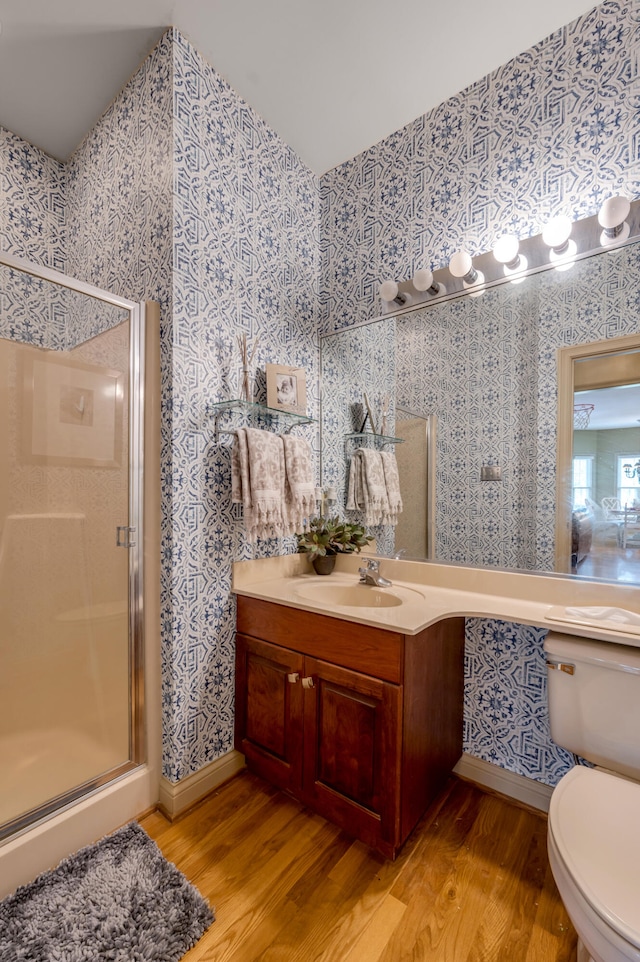 bathroom featuring vanity, an enclosed shower, toilet, and wood-type flooring