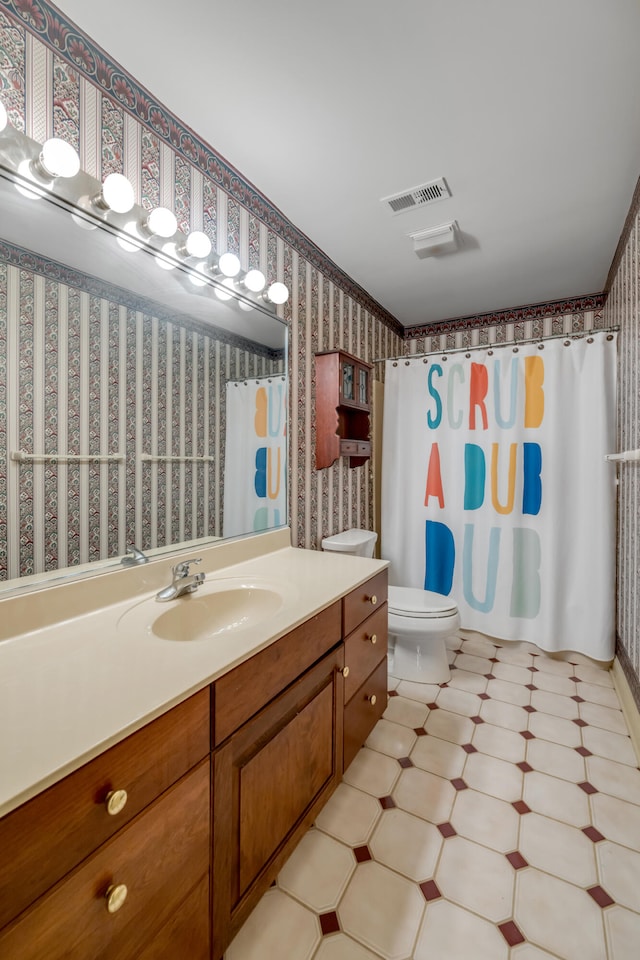 bathroom featuring vanity, toilet, and a shower with shower curtain