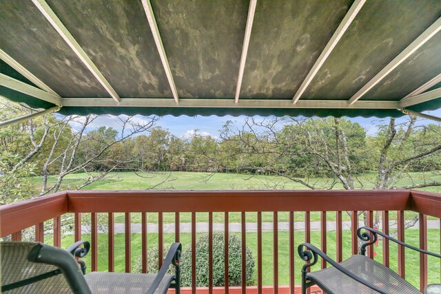 wooden terrace featuring a yard