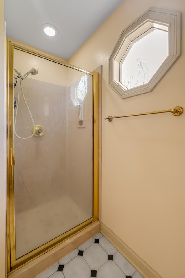 bathroom featuring a shower with shower door