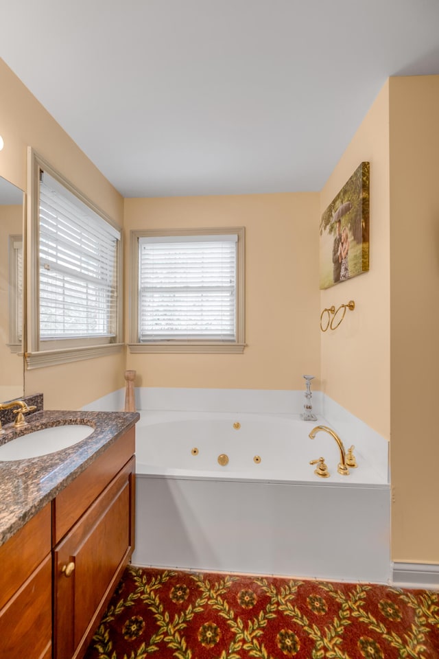 bathroom featuring vanity and a bath