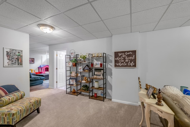 sitting room featuring a paneled ceiling and carpet flooring