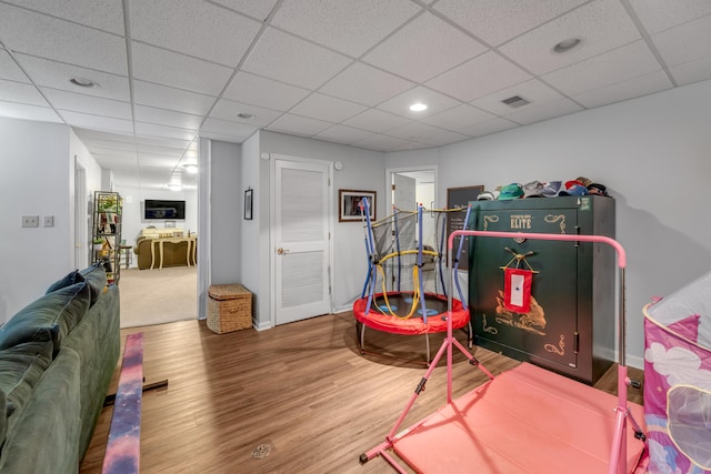 playroom with a drop ceiling and hardwood / wood-style floors