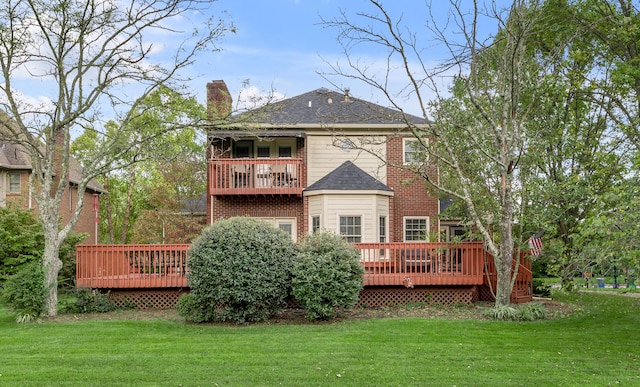 back of property featuring a wooden deck and a lawn