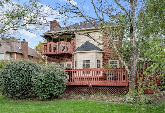 back of property with a balcony