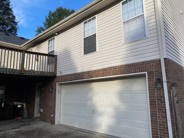 view of side of property with a deck and a garage