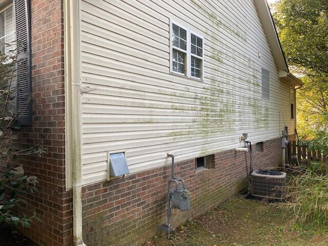 view of side of home featuring cooling unit