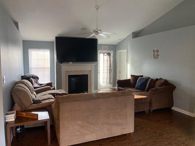 living room with dark hardwood / wood-style floors, ceiling fan, and vaulted ceiling