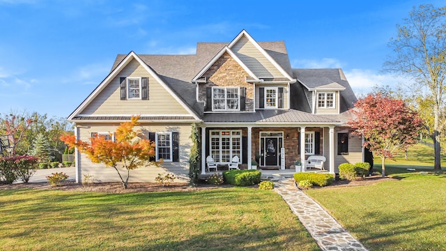 view of front of house featuring a front yard and covered porch