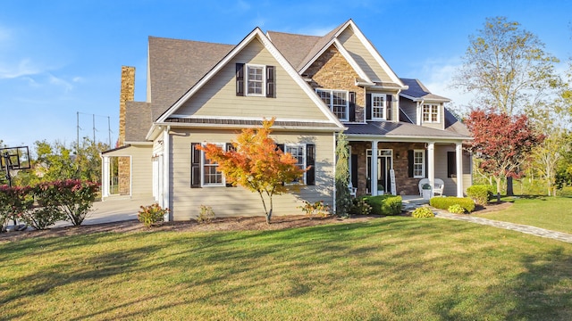 craftsman house with covered porch and a front lawn