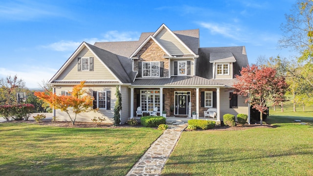 view of front of house featuring covered porch and a front lawn