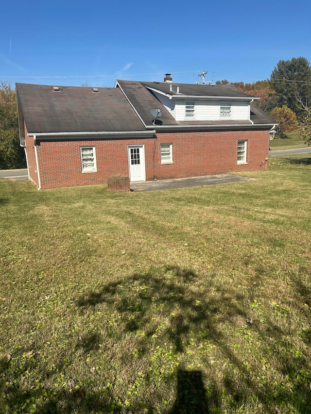 rear view of house with a lawn