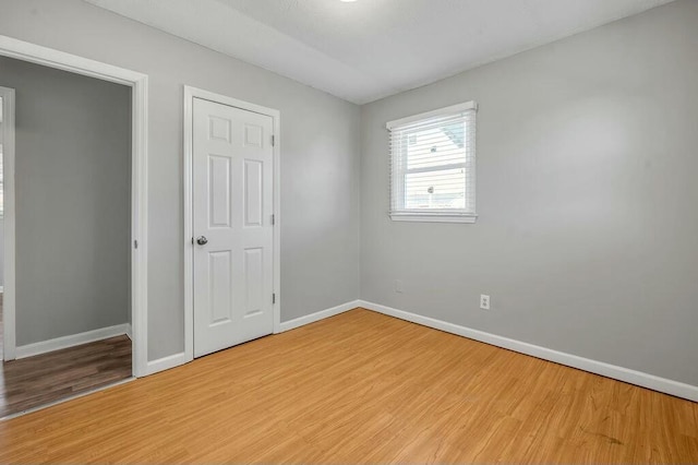 unfurnished bedroom featuring baseboards and light wood-style floors