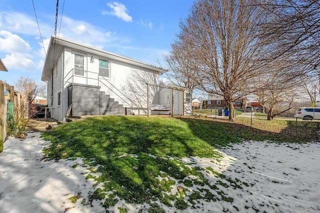 back of property with fence and stucco siding