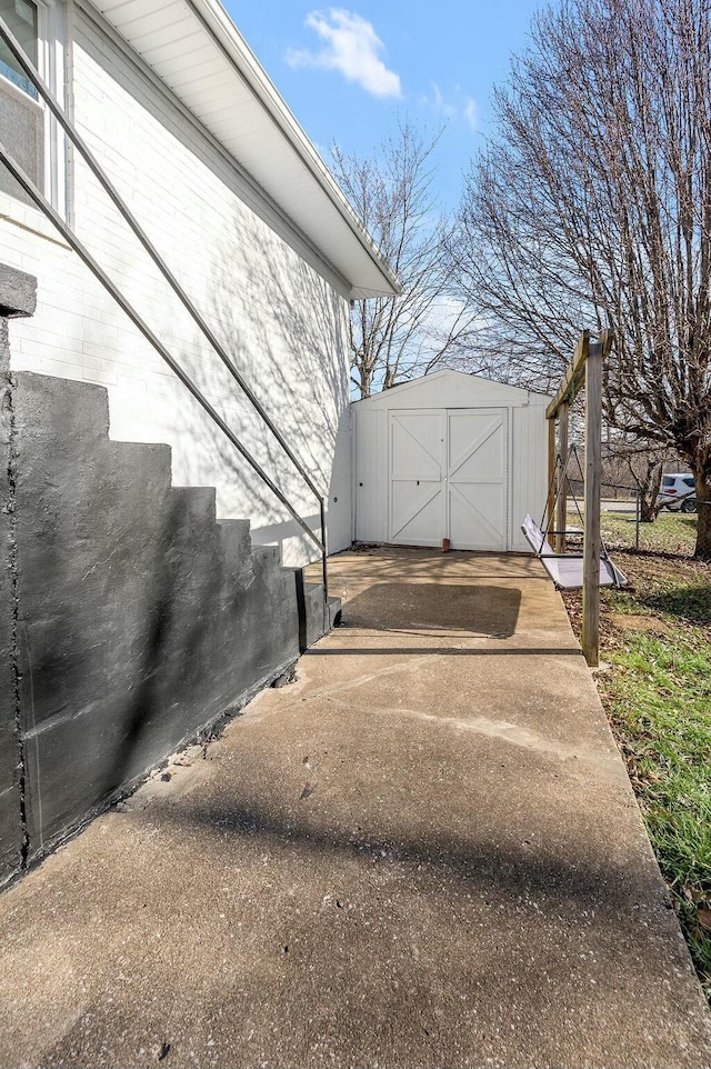 exterior space featuring a garage, an outbuilding, and a storage unit