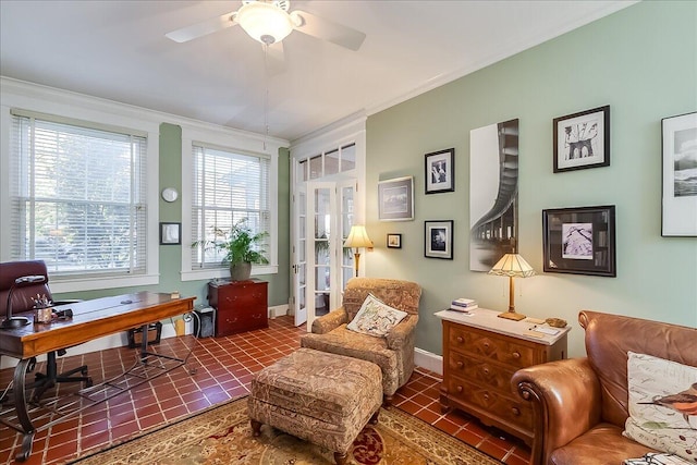 interior space with crown molding, dark tile patterned floors, and ceiling fan