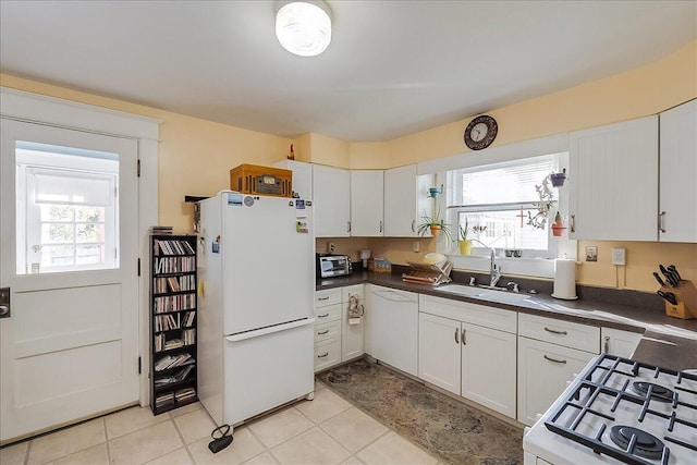 kitchen with a healthy amount of sunlight, sink, white cabinetry, and white appliances