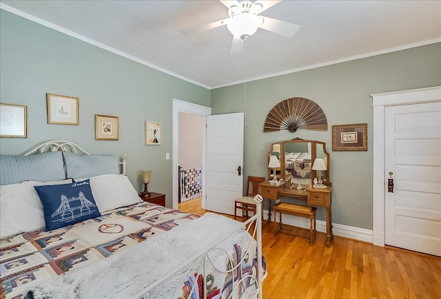 bedroom featuring ceiling fan, crown molding, and light hardwood / wood-style flooring