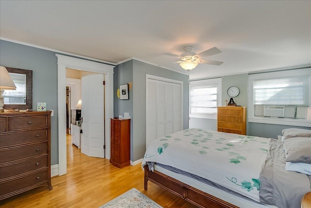 bedroom with a closet, ceiling fan, and light wood-type flooring