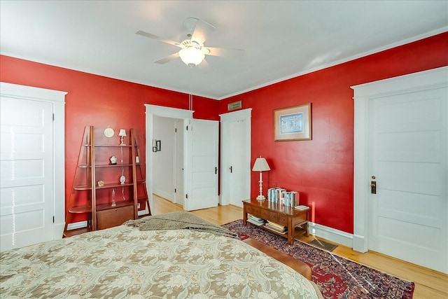 bedroom with ceiling fan and hardwood / wood-style flooring