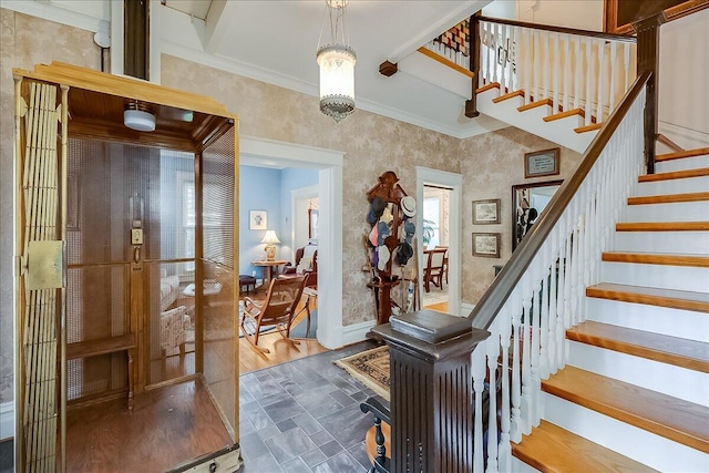 entryway featuring ornamental molding, hardwood / wood-style floors, a chandelier, and french doors