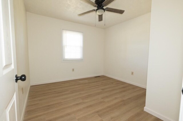 empty room featuring light wood-type flooring and ceiling fan