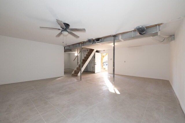 basement featuring ceiling fan and light tile patterned floors