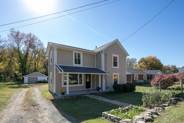 view of front property featuring an outdoor structure, a garage, and a front lawn