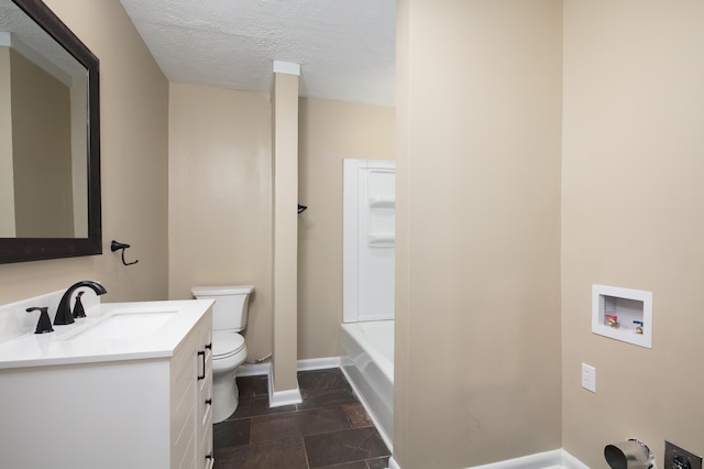 bathroom with toilet, a textured ceiling, and vanity