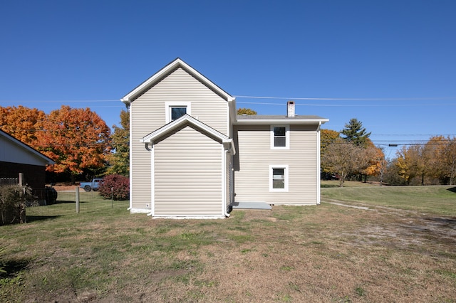 back of house featuring a yard