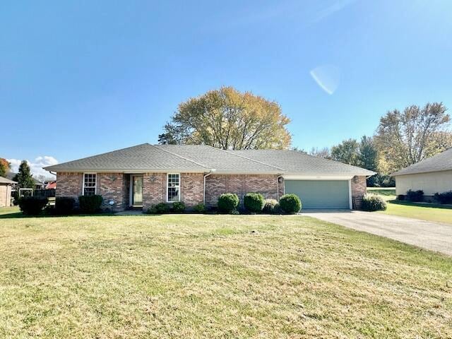 single story home with a front lawn and a garage