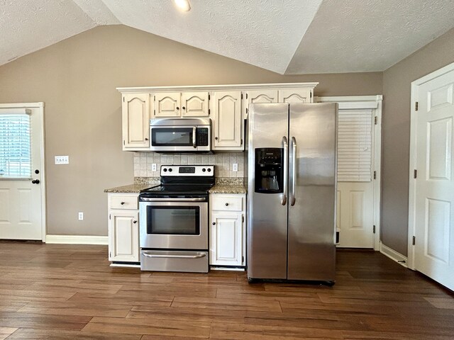 kitchen with dishwasher, lofted ceiling, sink, kitchen peninsula, and dark wood-type flooring