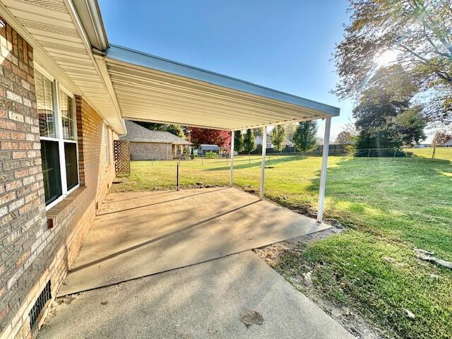 rear view of property with a lawn and a patio