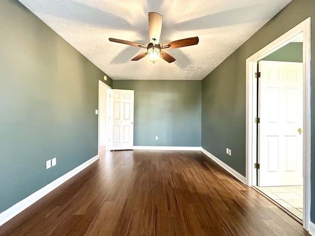 spare room featuring hardwood / wood-style floors, a textured ceiling, and ceiling fan