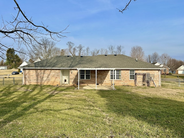 rear view of house featuring a yard and a patio area