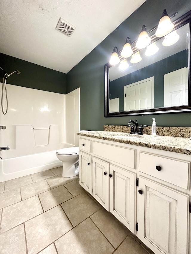 full bathroom featuring vanity, tile patterned flooring, bathing tub / shower combination, and toilet