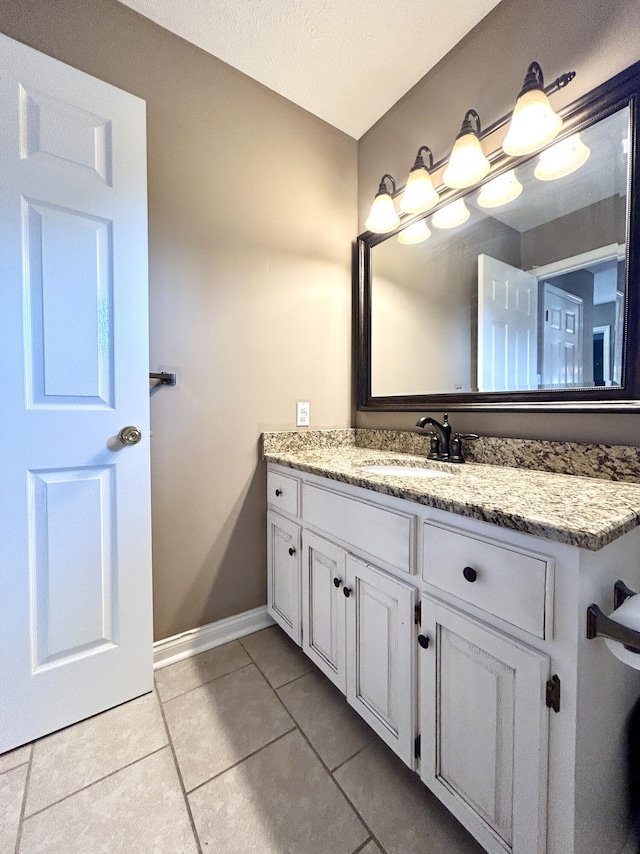 bathroom with vanity, tile patterned floors, and a textured ceiling