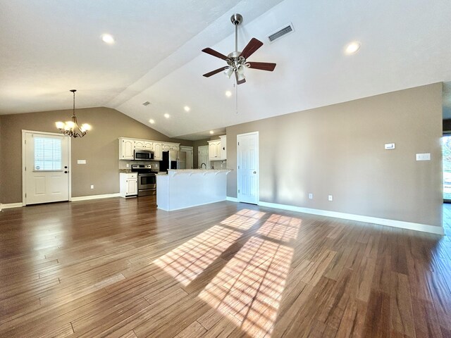 empty room featuring dark hardwood / wood-style flooring, vaulted ceiling, and ceiling fan