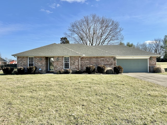 ranch-style house featuring a garage and a front yard