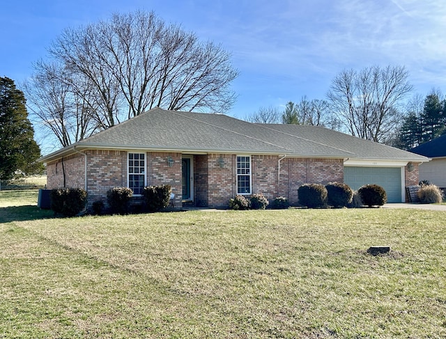 ranch-style house with a garage and a front lawn