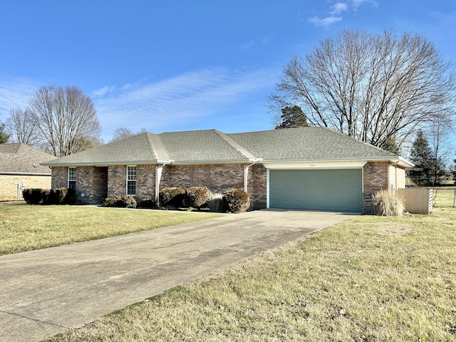 ranch-style house featuring a garage and a front yard