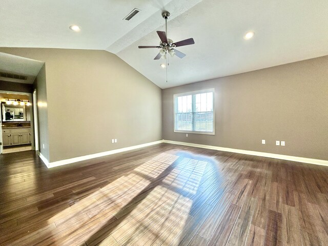 unfurnished living room featuring lofted ceiling, ceiling fan with notable chandelier, and dark hardwood / wood-style floors