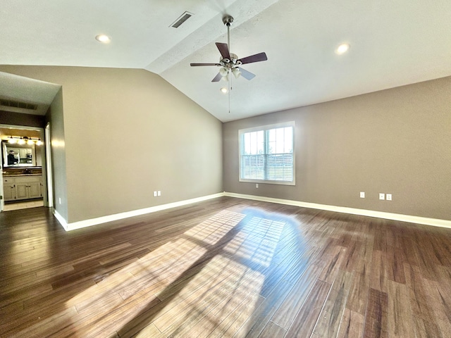 unfurnished room with vaulted ceiling, dark hardwood / wood-style floors, and ceiling fan